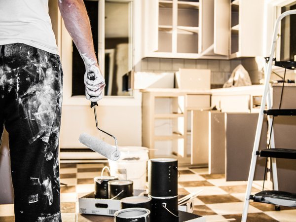 Man painting kitchen cabinets