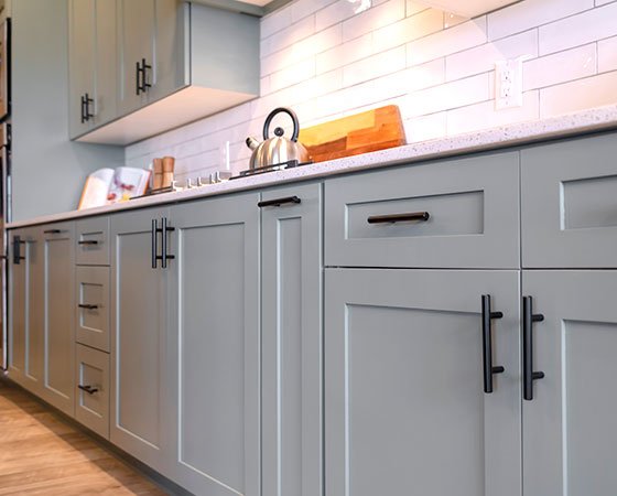 Gray kitchen cabinets with black handles