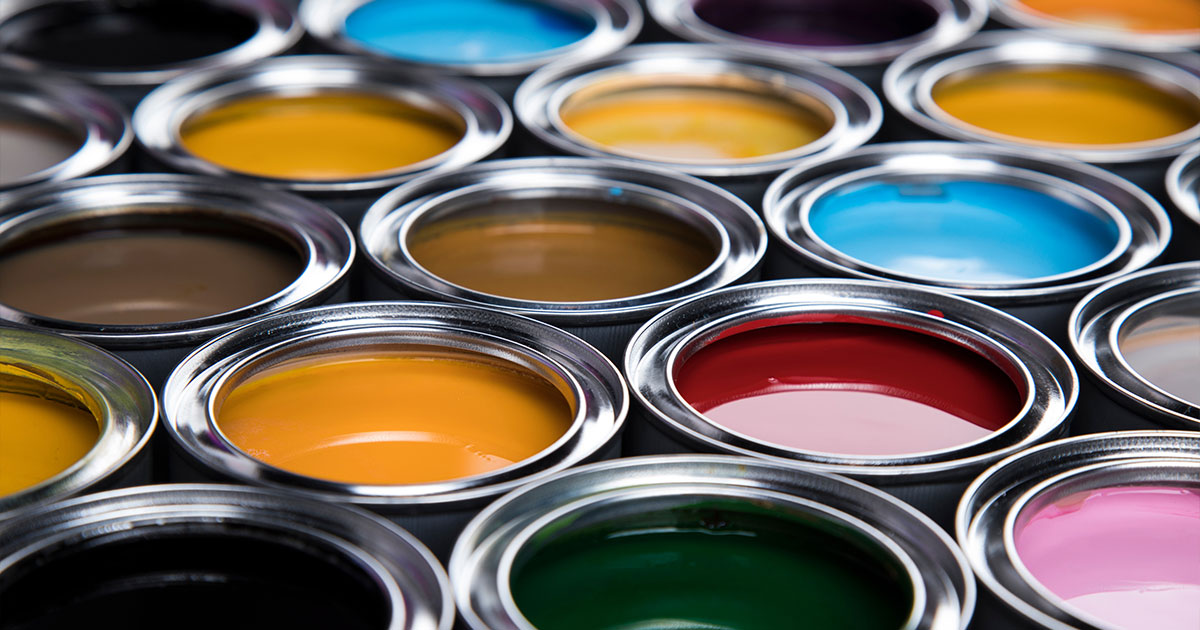 Colorful open paint cans displaying diverse shades for home painting and decoration projects.