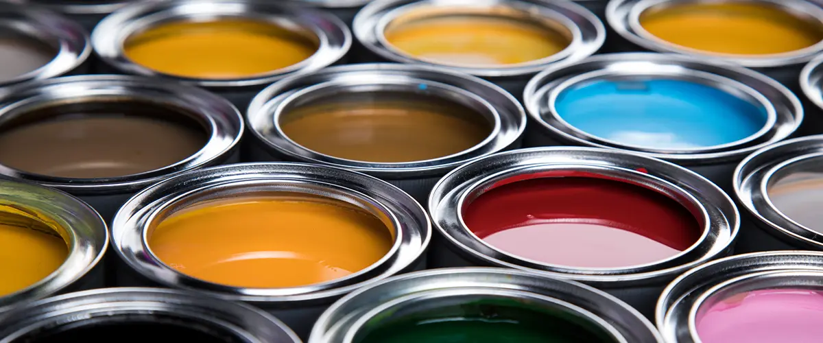 Colorful open paint cans displaying diverse shades for home painting and decoration projects.