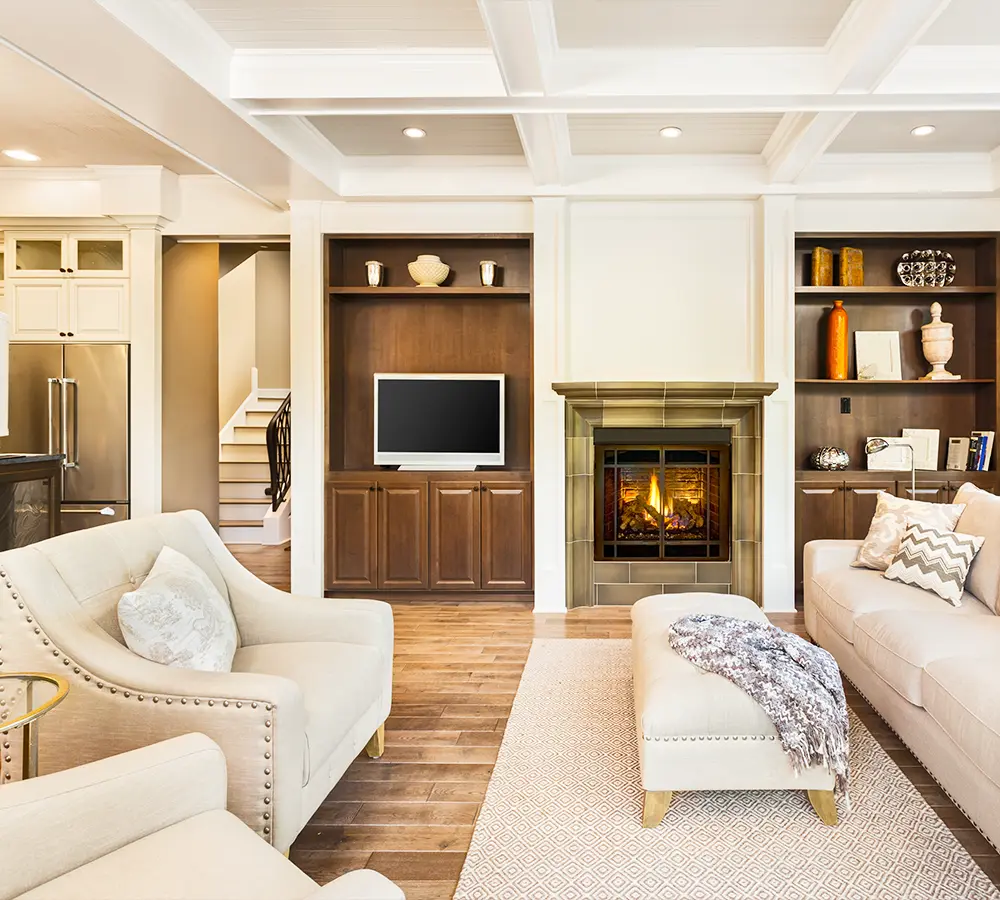 Elegant living room with fireplace, built-in shelving, and plush seating.