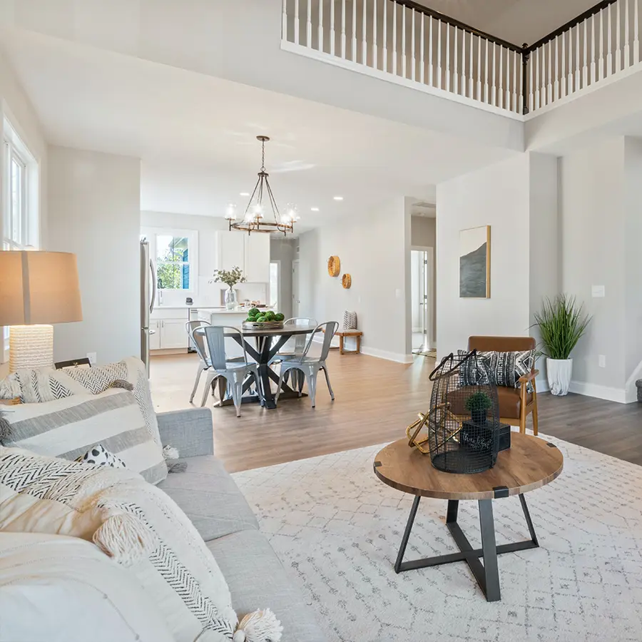 Modern open-concept living room with cozy seating and dining area.