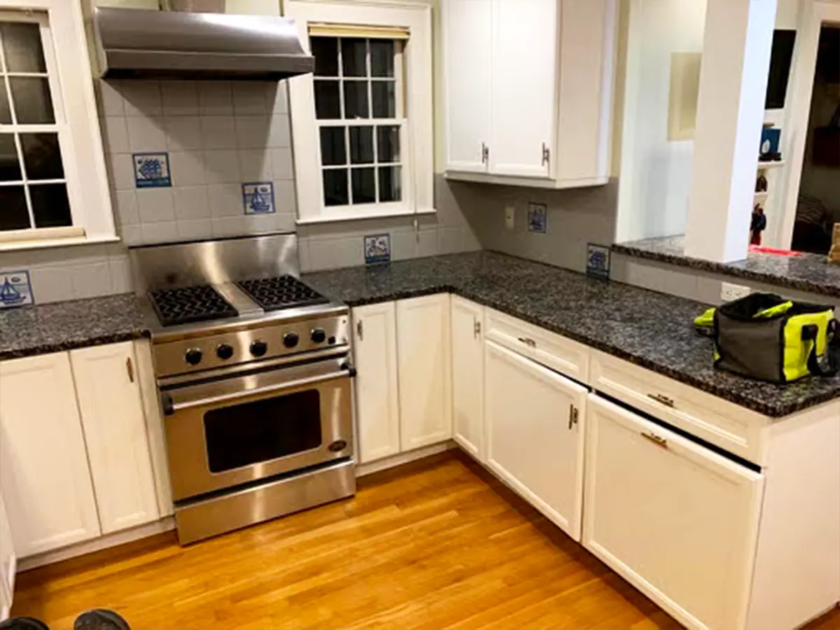 Kitchen with newly painted white cabinets and granite countertops for a contemporary finish.