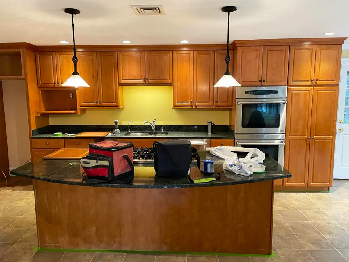 Natural wood kitchen cabinets awaiting a refinishing transformation for a modern update.