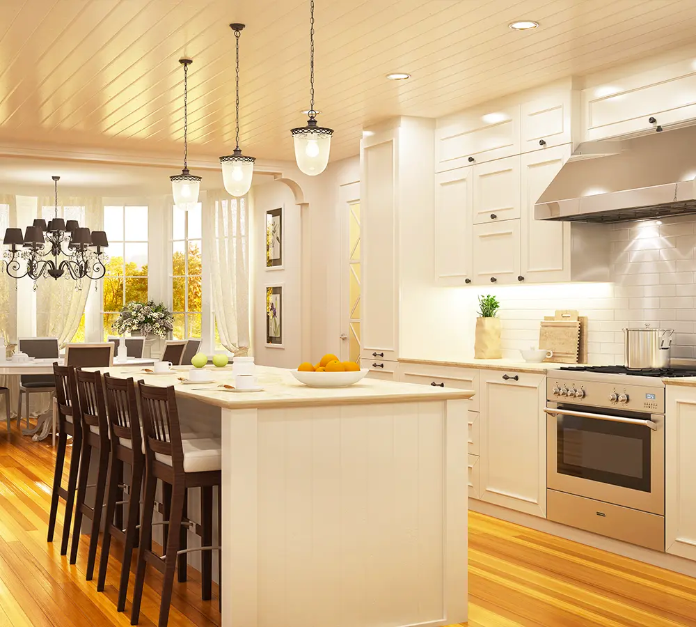 Elegant kitchen with cream-painted cabinets, large island, and pendant lighting in a spacious, bright dining area.