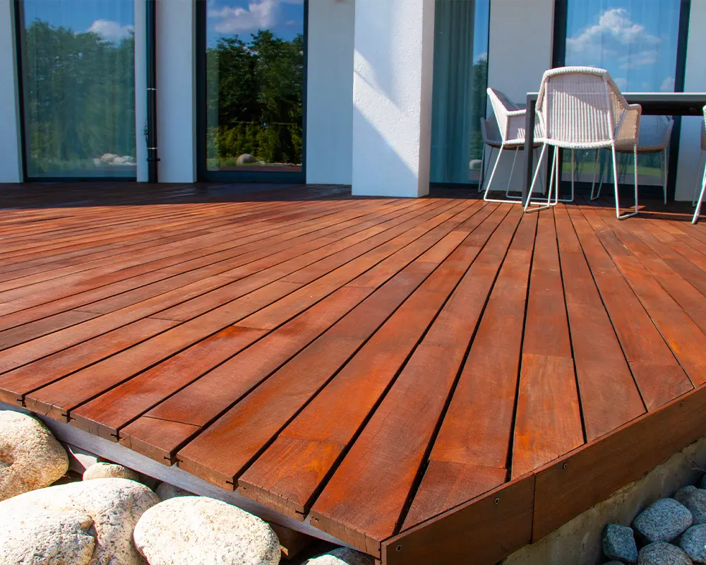 Finished wood deck with rich staining, showcasing polished and protected outdoor flooring.