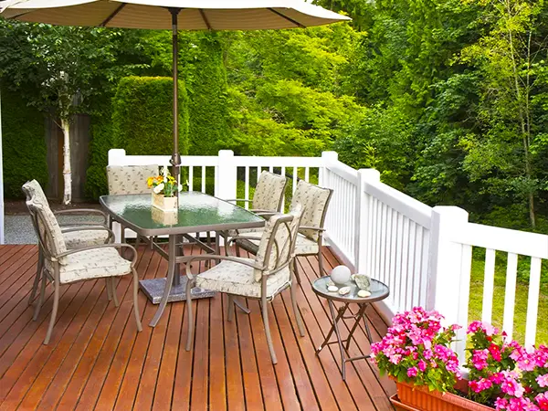 Beautifully stained deck with outdoor furniture setup, showcasing a cozy and inviting outdoor space.