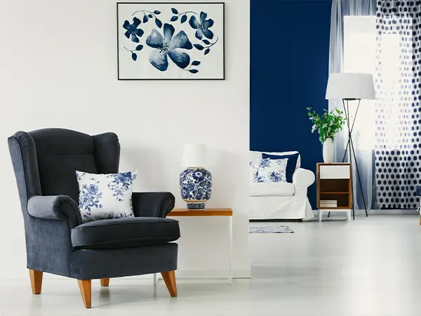 Modern living room with navy and white decor and a floral wall art piece